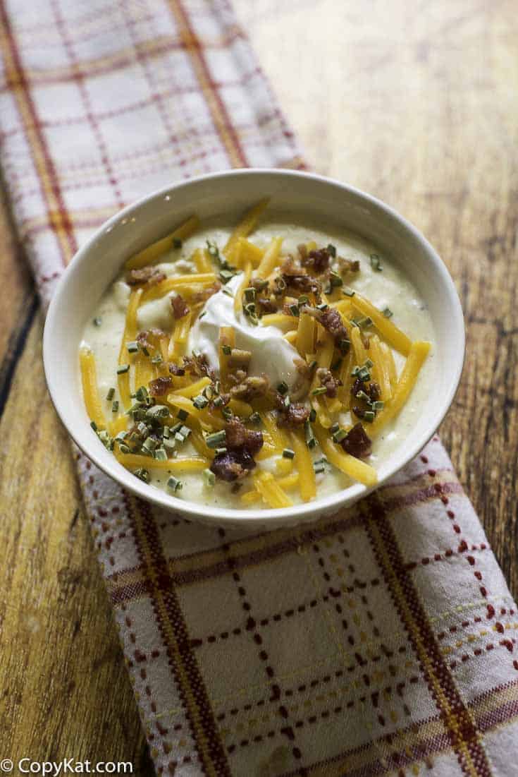 baked potato soup with cheese, sour cream, and scallions