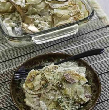 a plate of cheesy scalloped potatoes and ham