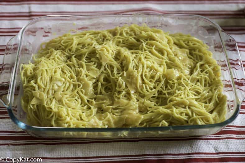 placing spaghetti in the pan