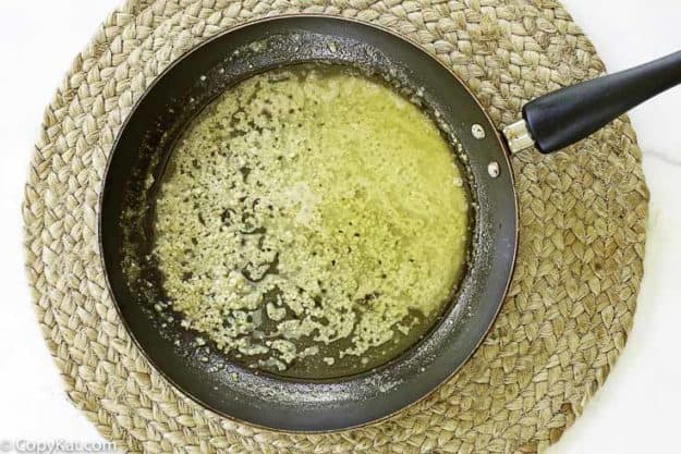 chopped garlic being sauteed in butter