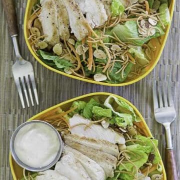 Two bowls of homemade Applebees Grilled Chicken Oriental Salad with Dressing