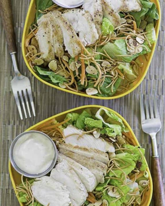 Two bowls of homemade Applebees Grilled Chicken Oriental Salad with Dressing