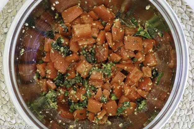 mixing chopped tomatoes and basil