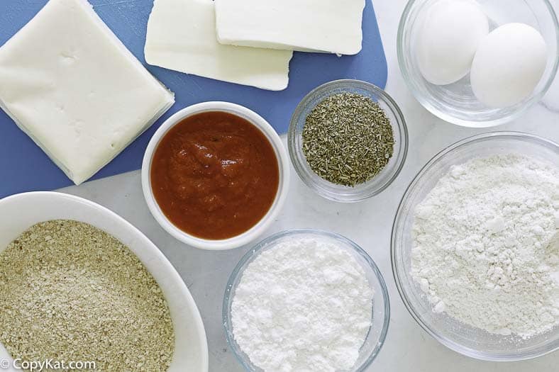 ingredients to make fried mozzarella sticks: mozzarella, bread crumbs, flour, eggs, and more