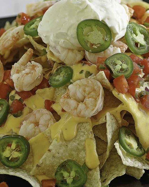 Nachos with cheese, jalapeno peppers, and shrimp