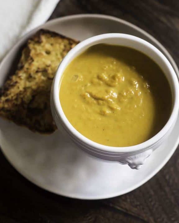 pumpkin soup in a bowl served with garlic bread