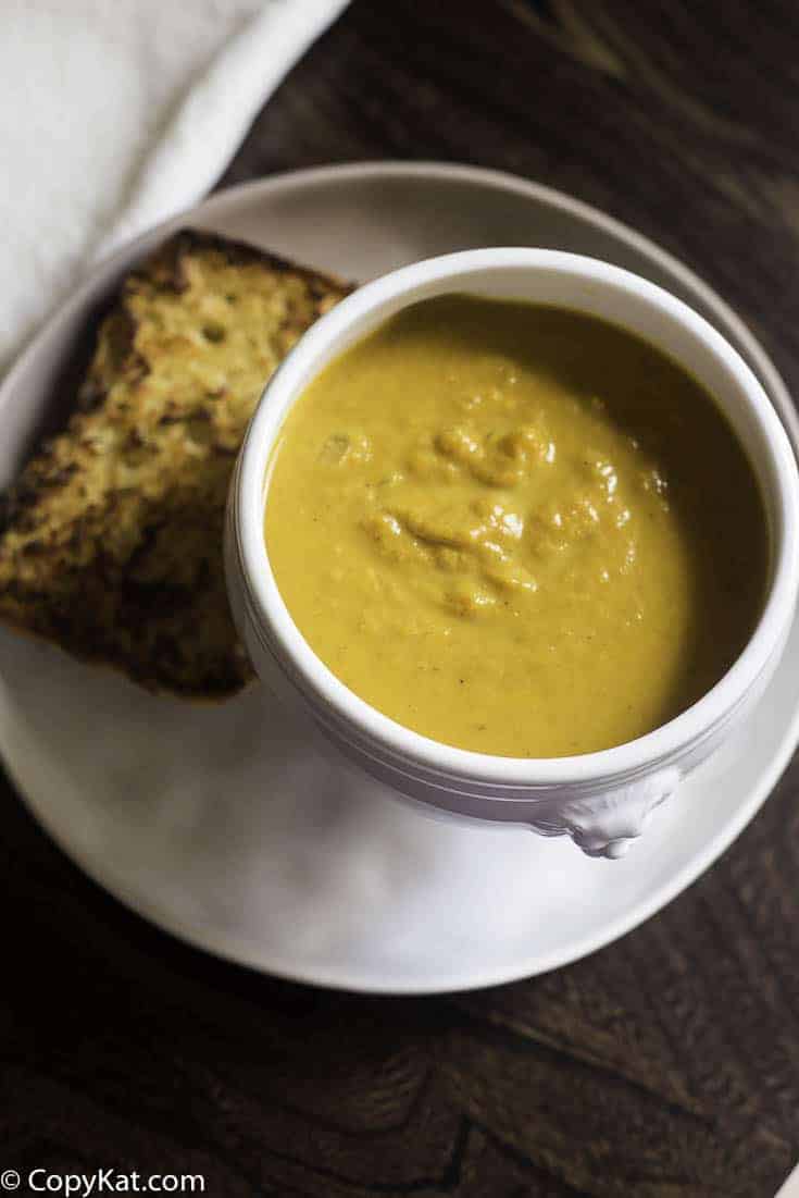 pumpkin soup in a bowl served with garlic bread