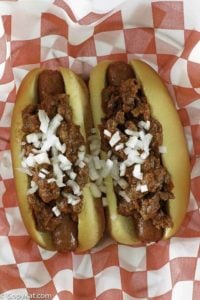 chili con carne on top of hot dogs