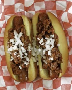 chili con carne on top of hot dogs