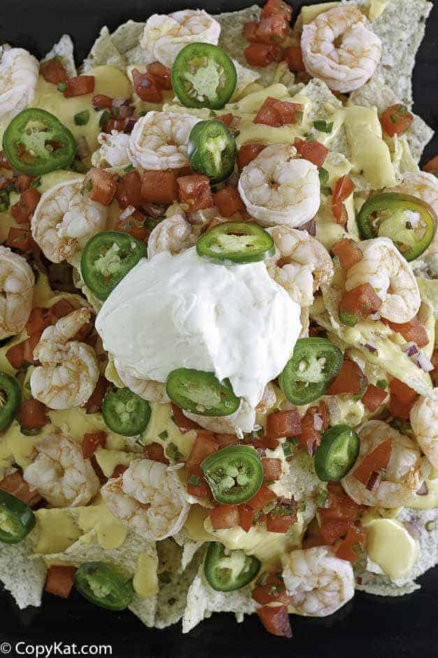 Cheesy nachos with shrimp, cheese, sour cream and more