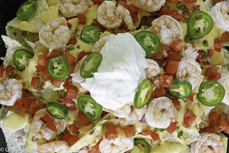 baked nachos with shrimp cheese peppers and sour cream
