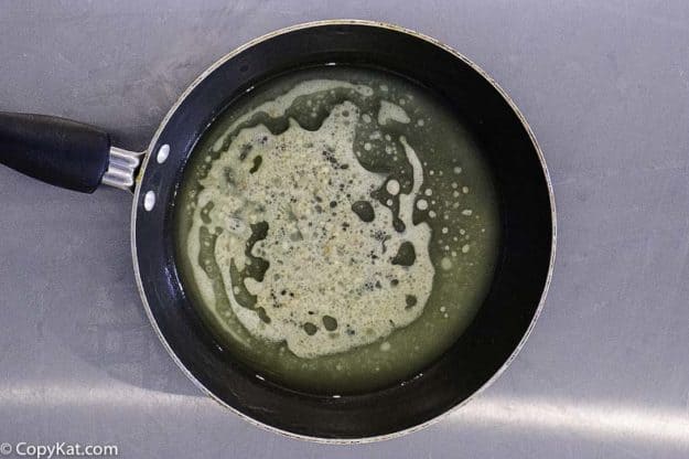 making garlic butter for green beans in a skillet