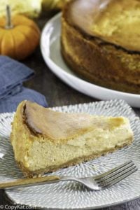 a slice if pumpkin cheesecake on a plate