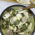 a trencher of potato and sausage soup with kale