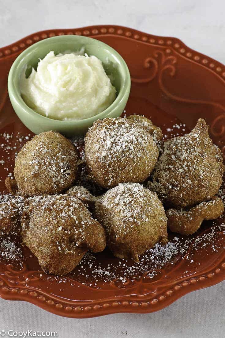 Denny's Strawberry Pancake Puppies on a plate with cream cheese dip