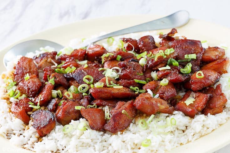 a plate of bourbon chicken on rice