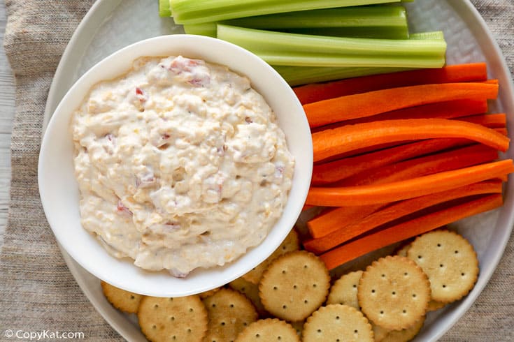 southern pimento cheese spread with crackers, celery, and carrots on a platter