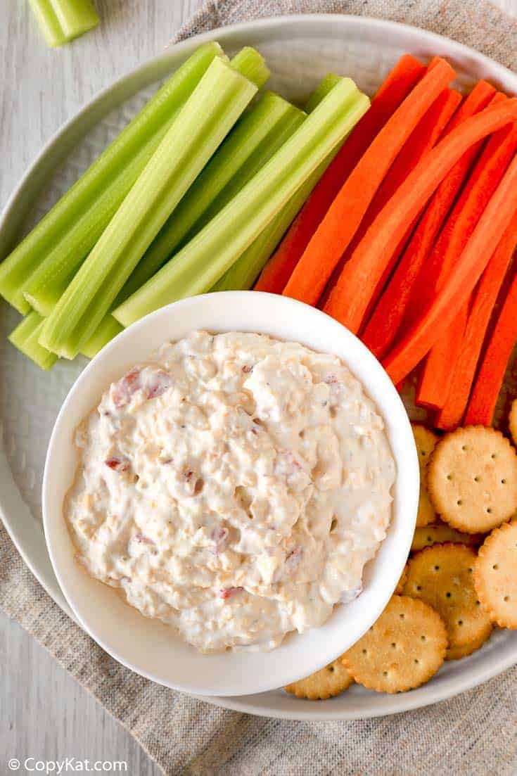 old fashioned pimento cheese spread on a platter with celery, carrots, and crackers