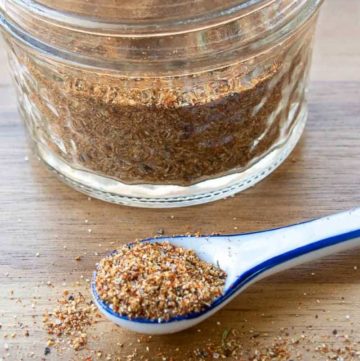 Red Lobster Cajun Spice Seasoning Mix in a measuring spoon and glass jar