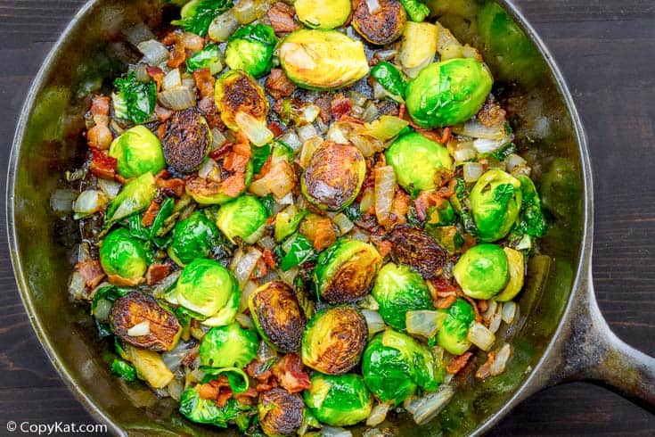 roasted brussels sprouts with bacon and onion in a cast iron skillet