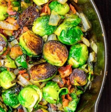 roasted brussels sprouts with bacon and onion in a skillet