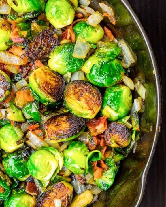 roasted brussels sprouts with bacon and onion in a skillet