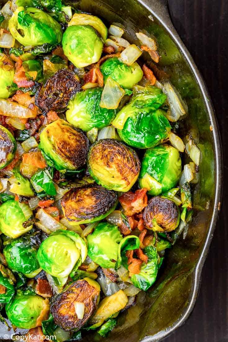 roasted brussels sprouts with bacon and onion in a skillet