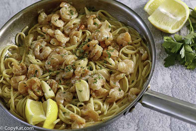 a skillet filled with shrimp and garlic pasta