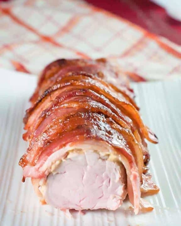brown sugar bacon wrapped pork tenderloin on a platter
