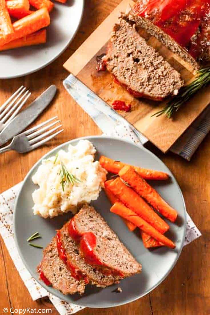 Homemade meatloaf with ketchup sauce served with mashed potatoes and carrots