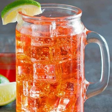 cherry limeade in a glass with a handle