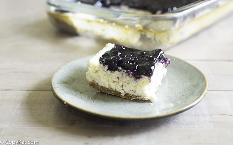 a piece of blueberry bar cheesecake