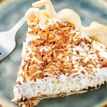 a slice of Bakers Square coconut cream pie on a blue plate