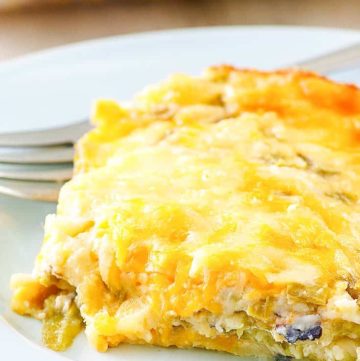 a slice of chili relleno casserole and a fork on a plate