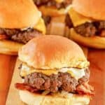 mini cheeseburgers (sliders) on a wood cutting board