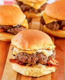 mini cheeseburgers (sliders) on a wood cutting board