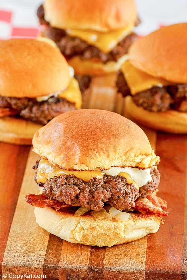 mini cheeseburgers (sliders) on a wood cutting board