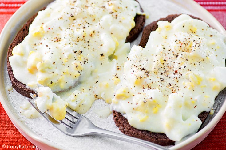 two creamed eggs on toast on a plate