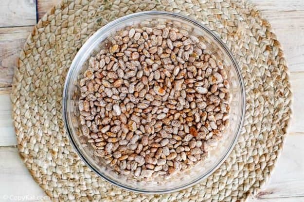 dried pinto beans in a glass bowl