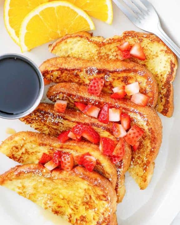 french toast with chopped strawberries on top.
