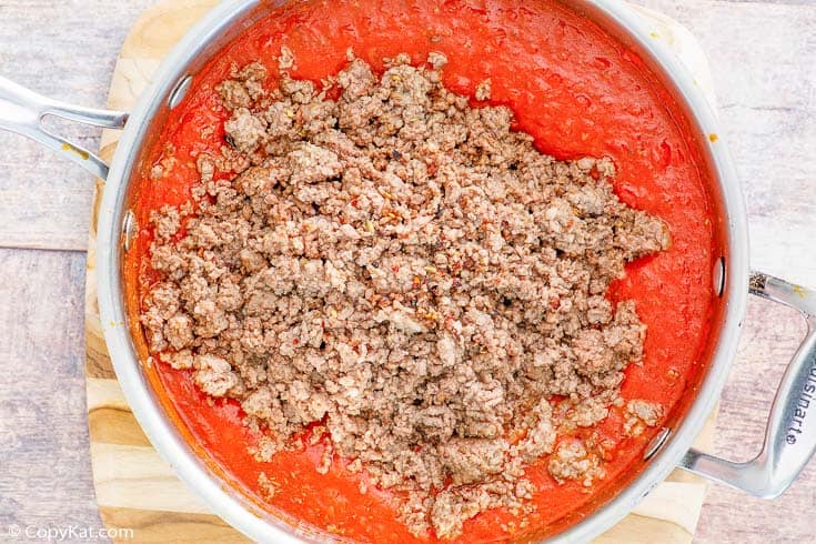three meat sauce ingredients in a skillet
