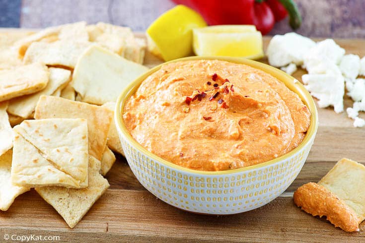 crackers and a bowl of roasted red pepper dip