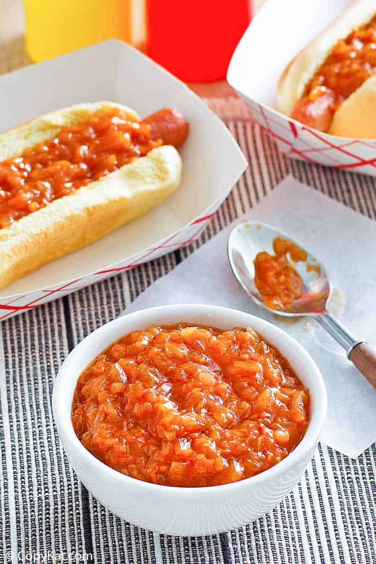 homemade Sabrett onion sauce in a bowl and on two hot dogs