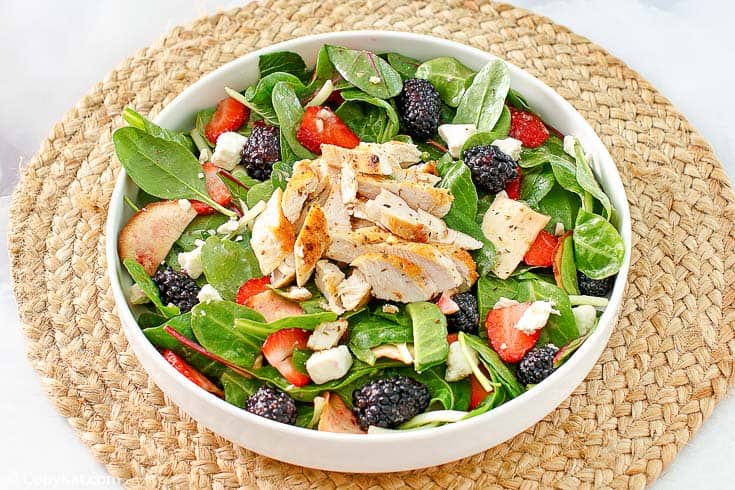 a bowl of berry chicken salad with feta cheese