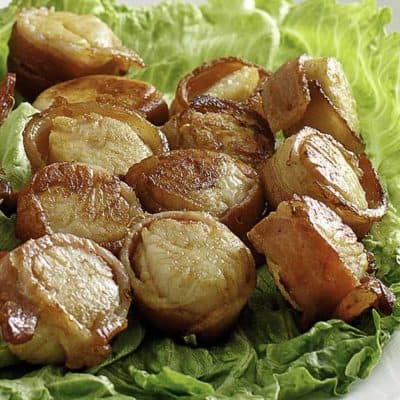 baked bacon wrapped scallops on a platter