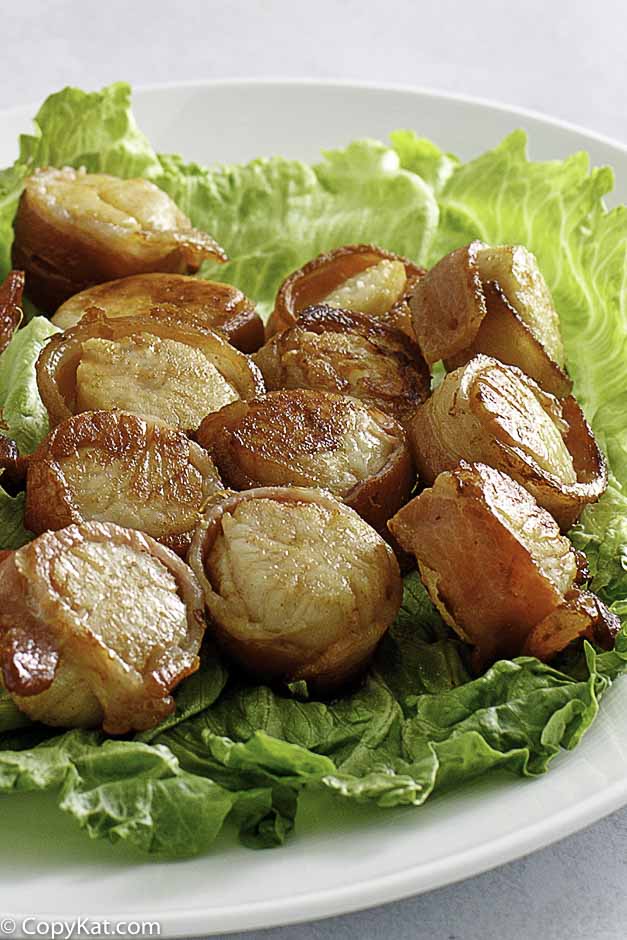 baked bacon wrapped scallops on a platter