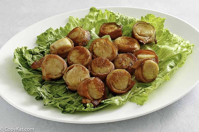 a platter of bacon wrapped scallops