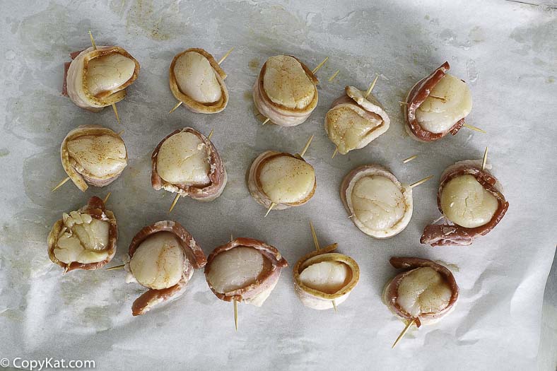 marinated scallops wrapped in bacon before baking