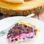 a slice of blueberry cream cheese pie on a white plate