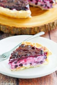 a slice of blueberry cream cheese pie on a white plate